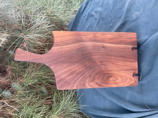 Charcuterie board with a short handle painted with black walnut.