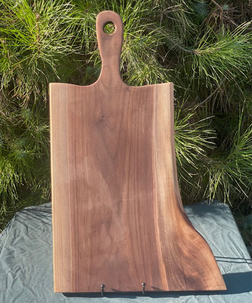 Charcuterie boards with different shape standing on table.