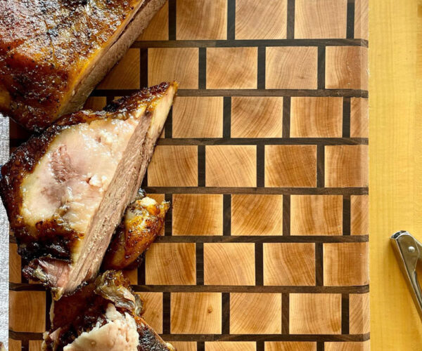 Cut up meats on a cutting board.