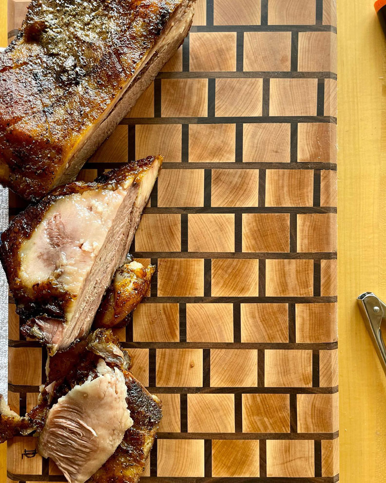 Cut up meats on a cutting board.