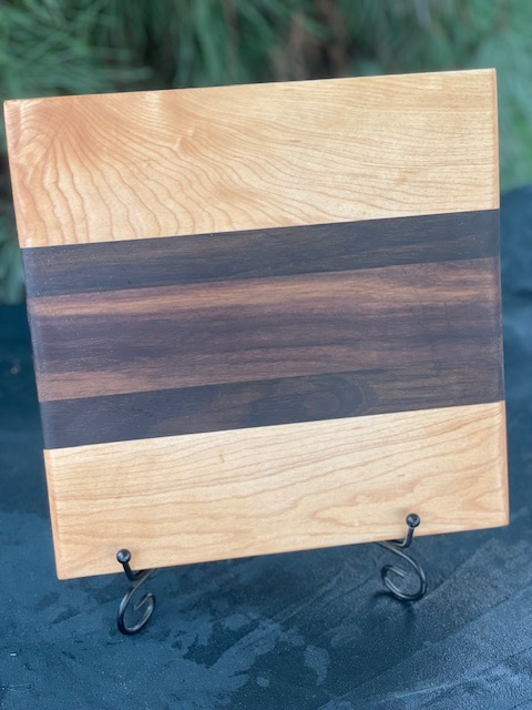 Maple, Peruvian walnut, and black walnut colored cutting board.