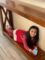 Long custom wood farmhouse table with elf. Young girl lying on the bottom of table.